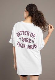 Person wearing a white t-shirt with text on the back against a plain background