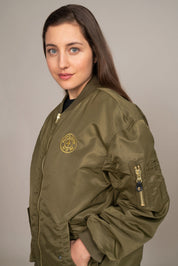 closeup side view of woman in green golds gym jacket