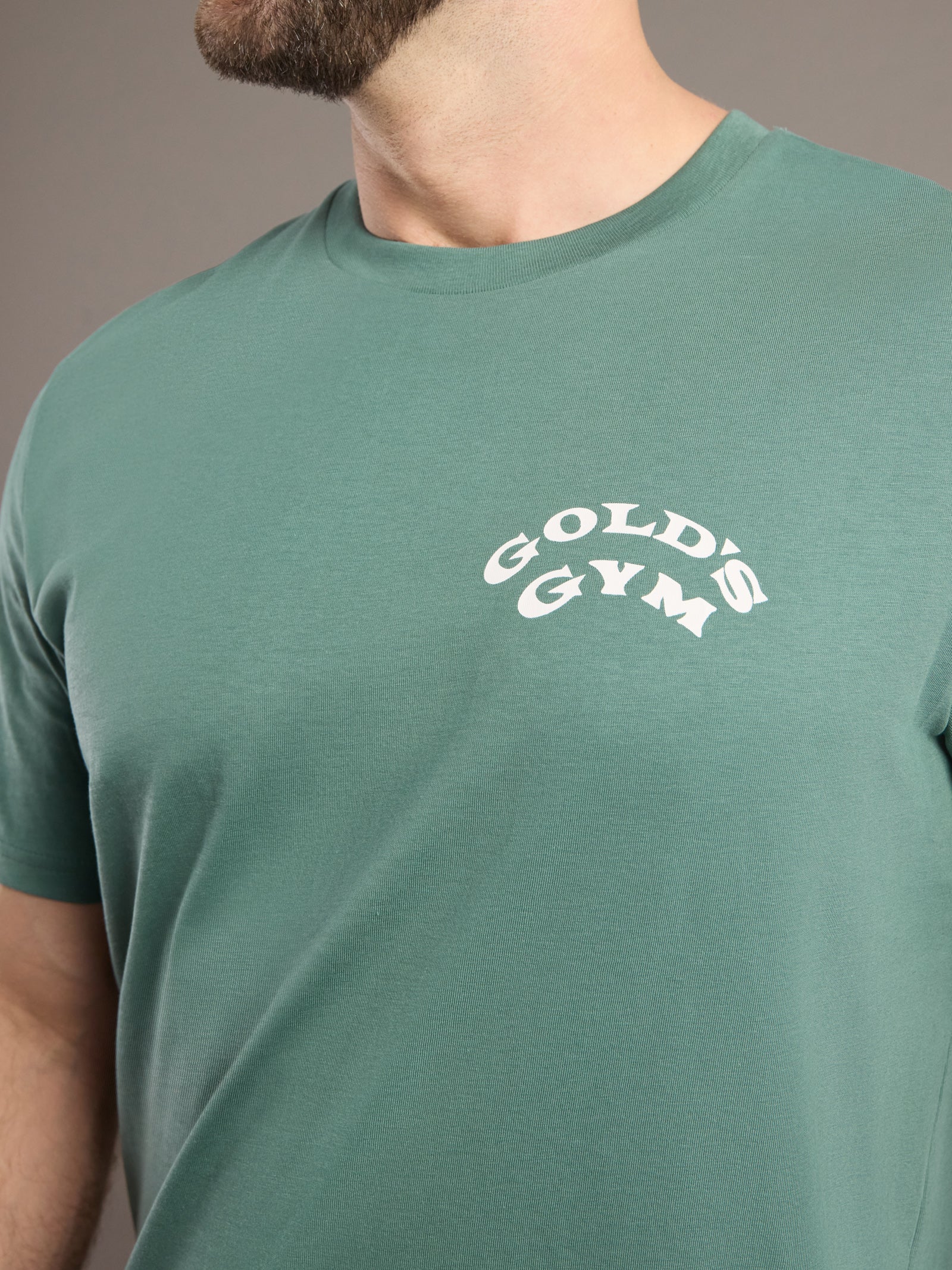 Green t-shirt with Gold's Gym logo worn by a person