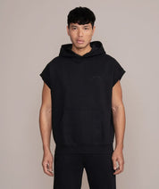 man wearing oversized sleeveless hoodie for gym