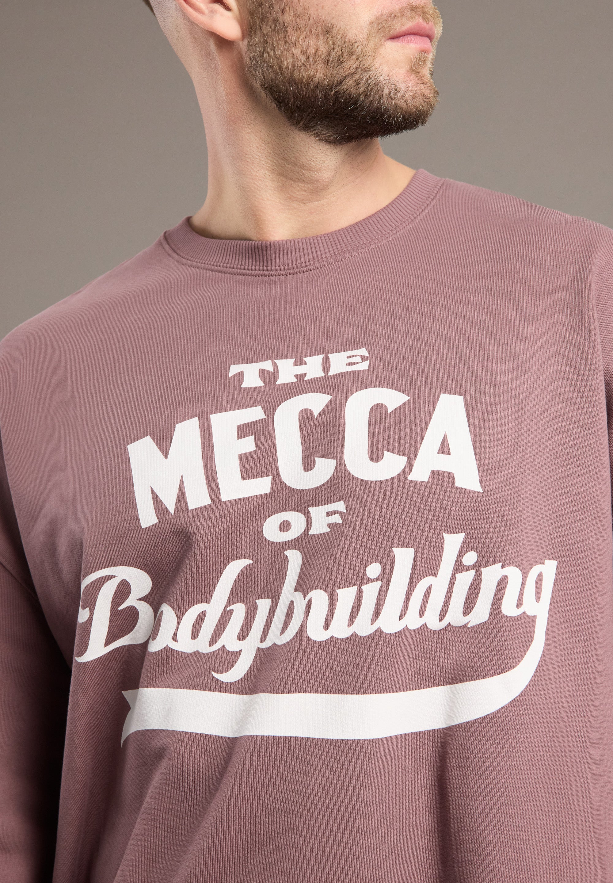 Maroon sweatshirt with 'The Mecca of Bodybuilding' text on a plain background