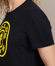 side view of woman in black golds gym shirt