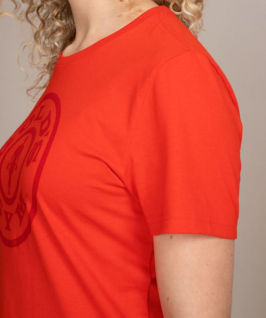 side view of woman in red golds gym shirt
