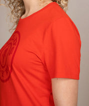 side view of woman in red golds gym shirt