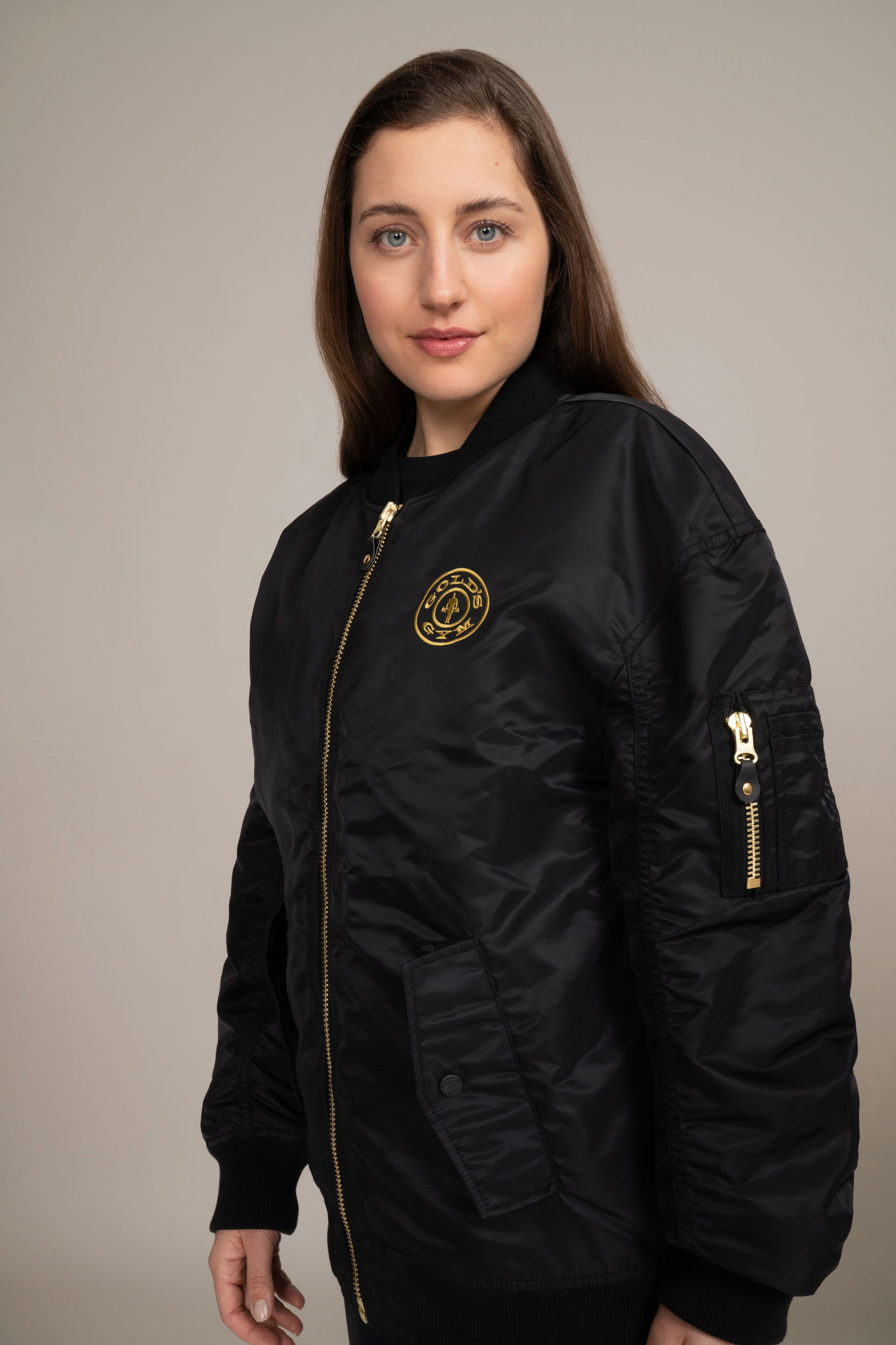 woman in golds gym bomber jacket