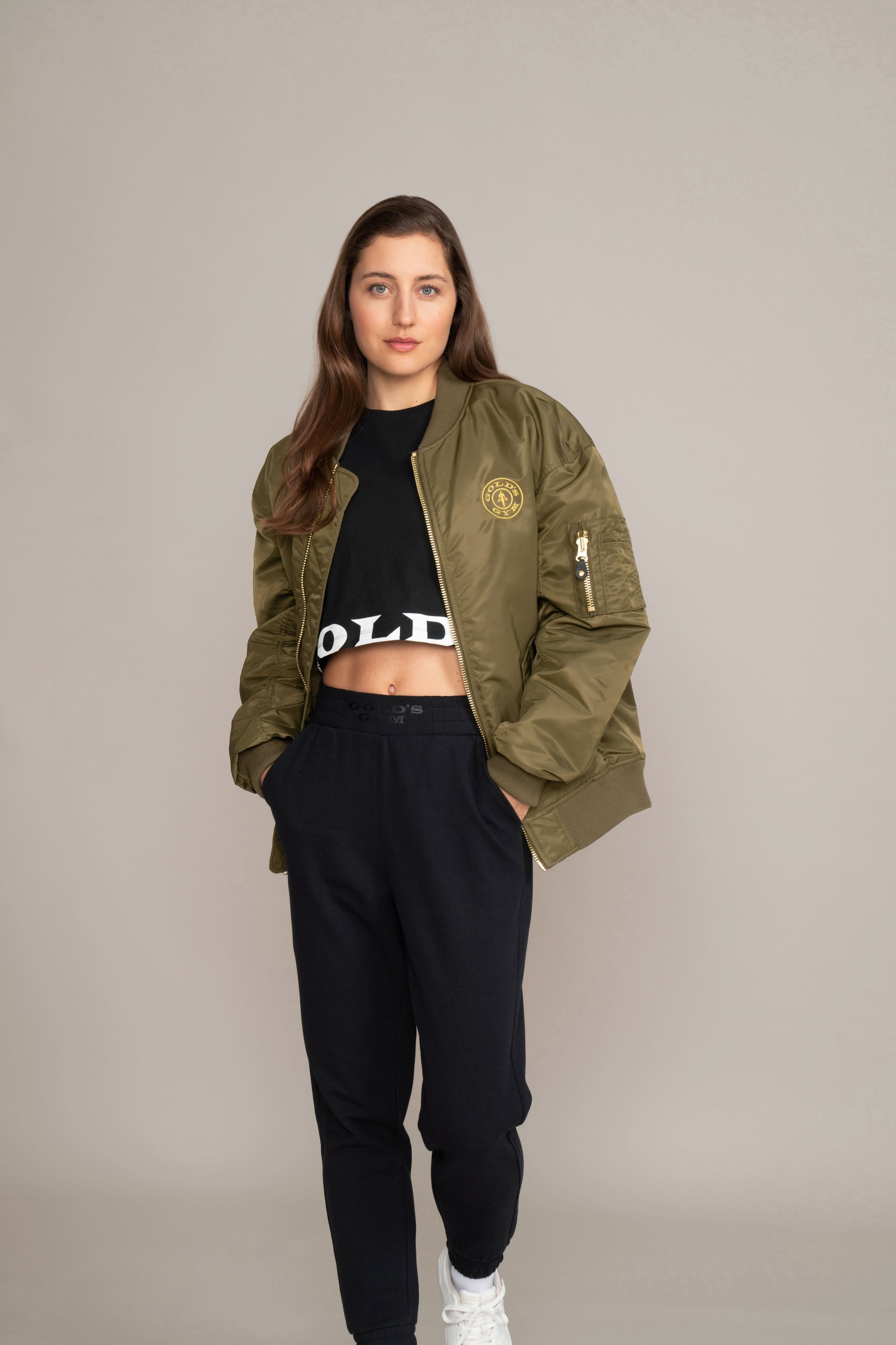 woman in green golds gym jacket