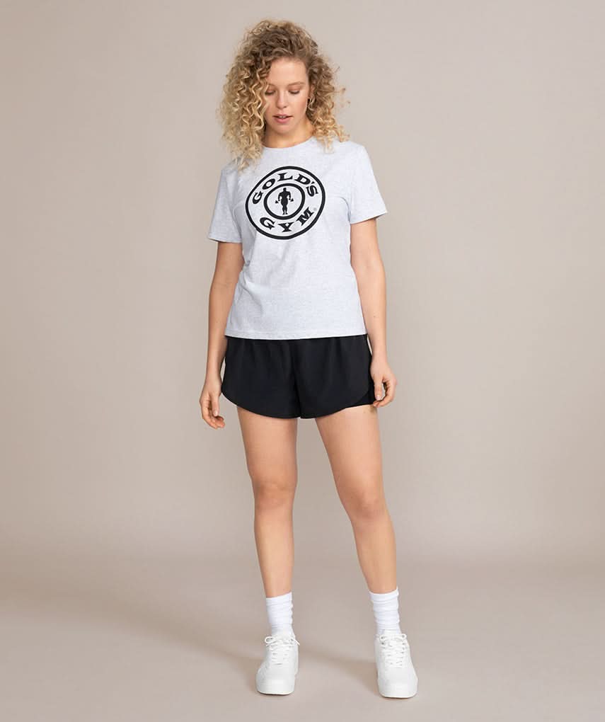 woman looking down in gray golds gym shirt
