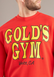 Red Gold's Gym sweatshirt with yellow text on a neutral background