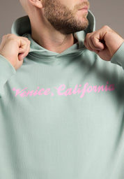 Light gray hoodie with 'Venice, California' text in pink on a neutral background