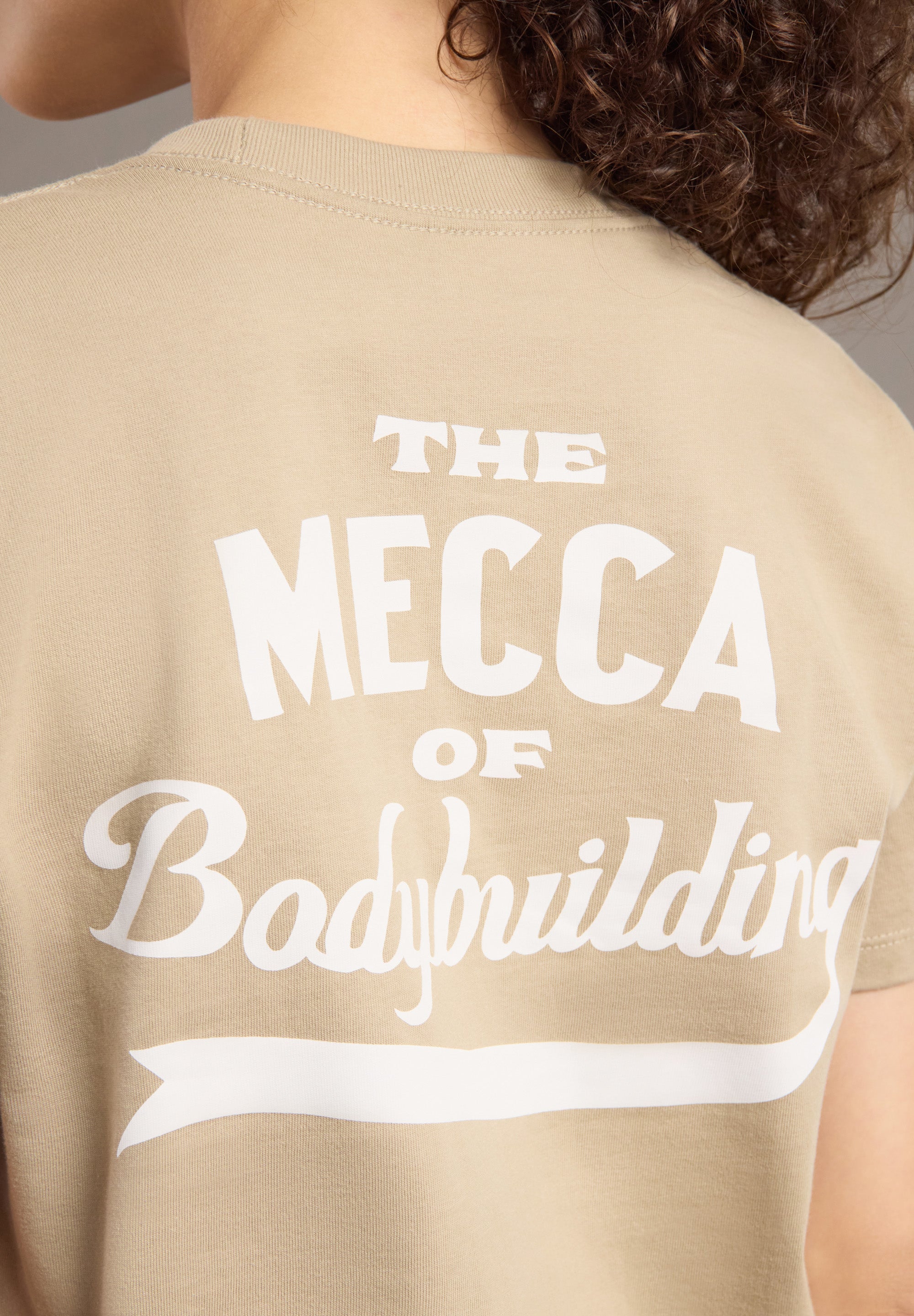 Beige t-shirt with 'The Mecca of Bodybuilding' text on the back