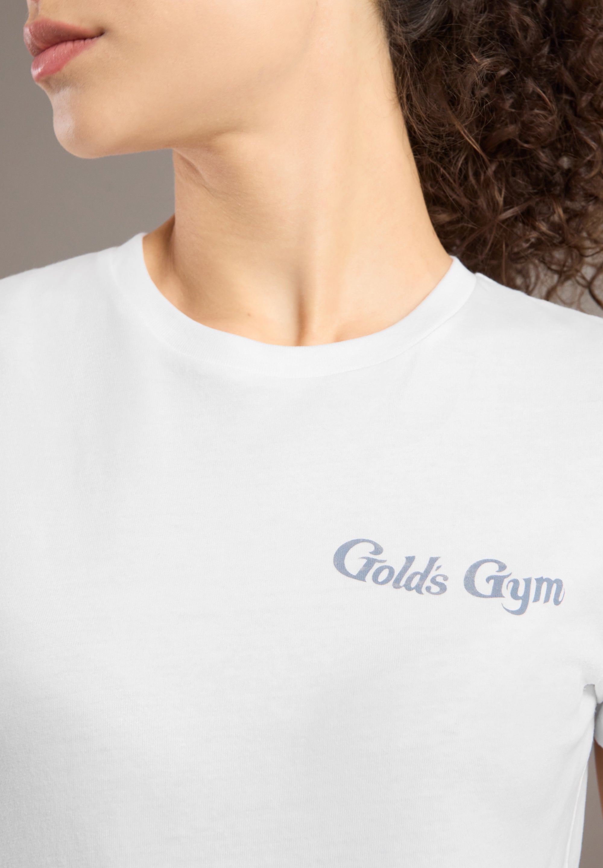 White t-shirt with 'Gold's Gym' logo worn by a person