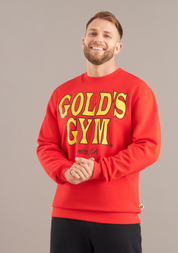 Man wearing a red 'Gold's Gym' sweatshirt against a gray background