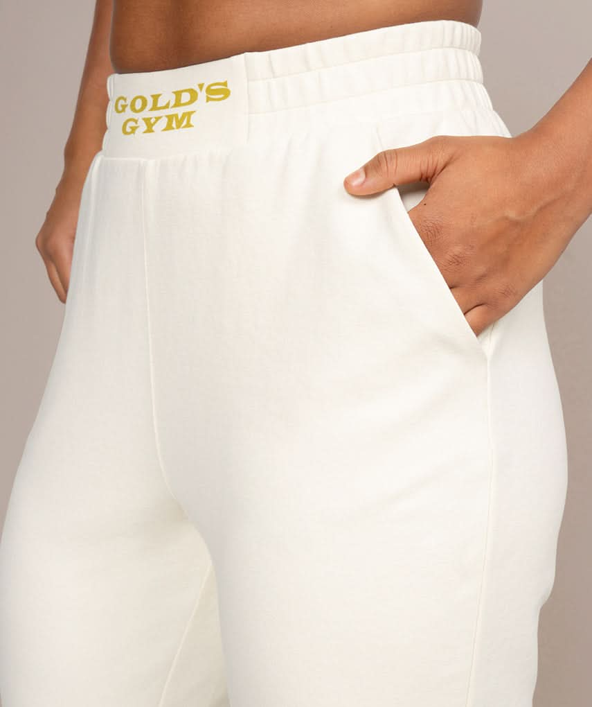womens jogger sweatpants with golds gym logo in off white side view 