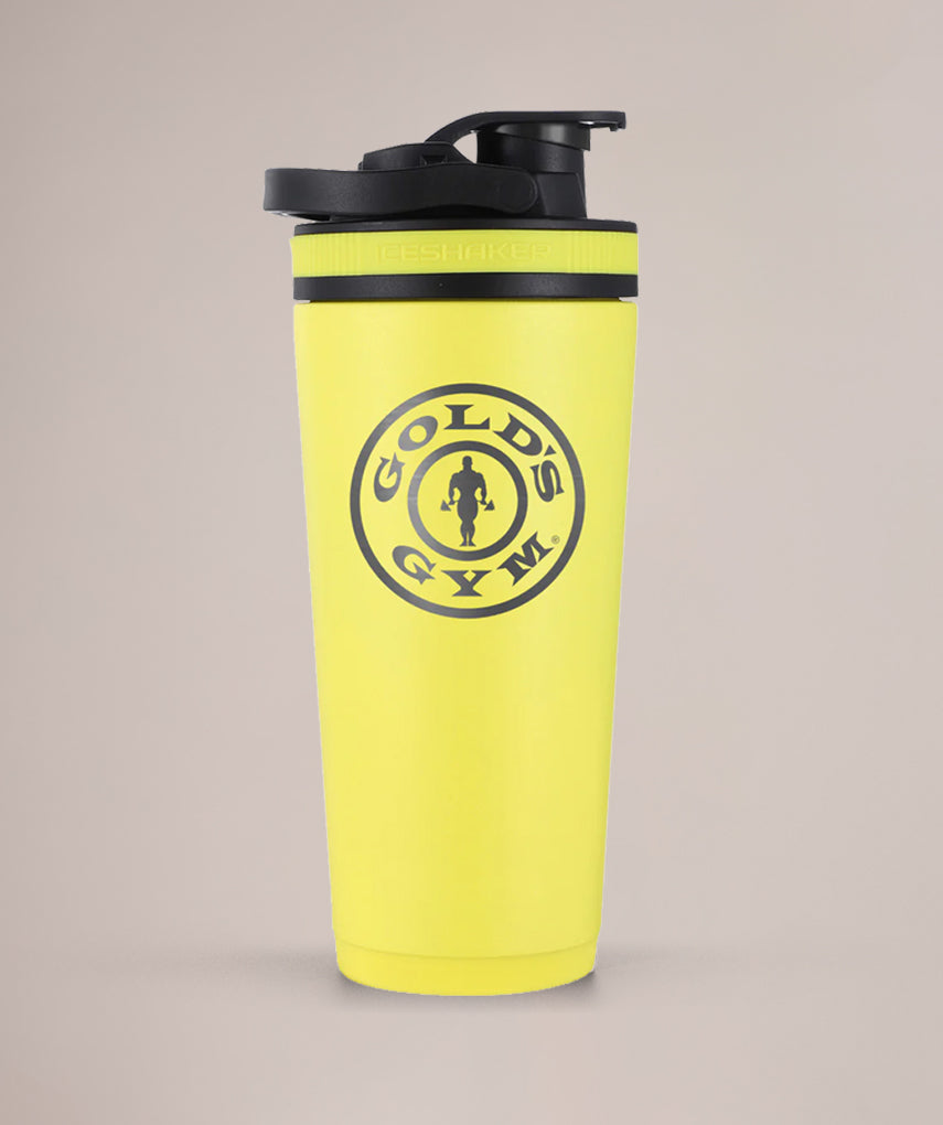 Yellow Gold's Gym shaker bottle on a beige background